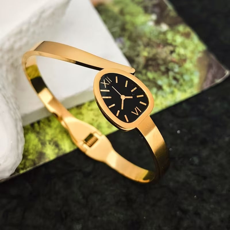 A Women'S Bracelet in a Classic Watch Design Featuring Roman Numerals Etched Into The Open Strap, Made of Stainless Steel