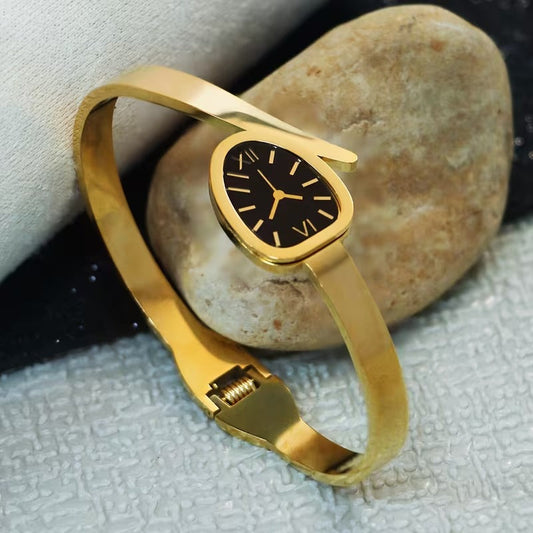 A Women'S Bracelet in a Classic Watch Design Featuring Roman Numerals Etched Into The Open Strap, Made of Stainless Steel