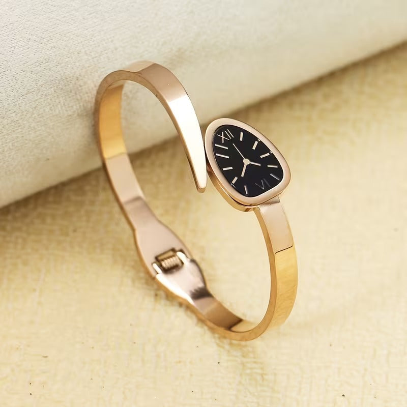 A Women'S Bracelet in a Classic Watch Design Featuring Roman Numerals Etched Into The Open Strap, Made of Stainless Steel